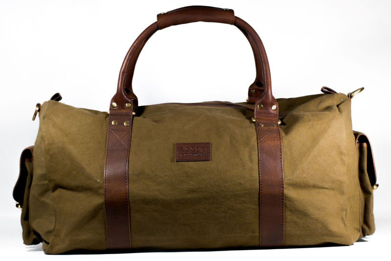 A White Cap Waxed Canvas Duffle bag with leather straps and antique brass hardware by Rogue Industries.