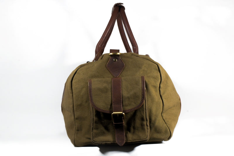 A green White Cap Waxed Canvas Duffle bag with brown straps by Rogue Industries.