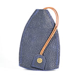 A dark blue durable cowhide Rogue Leather Key Protective Case by Rogue Industries with a brown leather strap loop and a brass button closure, standing upright on a white background.