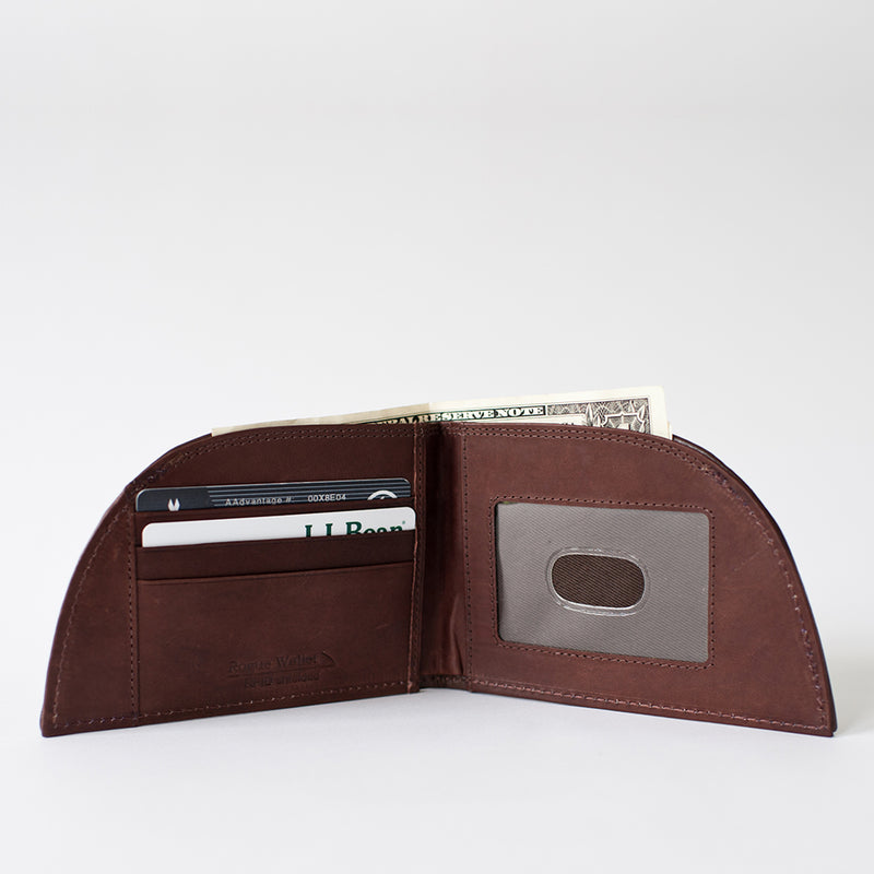 A brown leather NON-RFID Made in Maine wallet by Rogue Industries with a credit card in it.