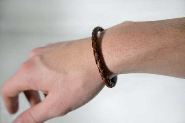 A person's hand with a Rogue Industries Rogue Braided Moose Leather Bracelet on it.