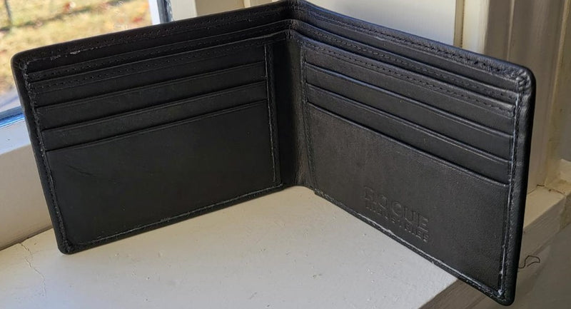 A black, Rogue Industries R11 top-grain leather wallet sitting on a window sill.