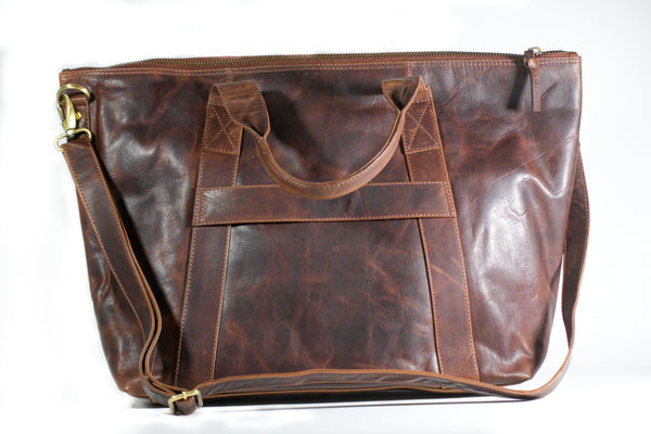 A brown full-grain leather Rockport weekend tote bag by Rogue Industries on a white background.