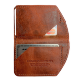A brown, slim leather Rogue Industries Minimalist Wallet with a credit card in it.