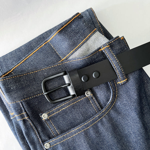 A pair of jeans with a handmade, Rogue Industries Baxter Leather Belt - 1.5" Wide.