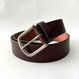 A handmade Baxter Leather Belt - 1.5" Wide in brown cowhide leather with a silver buckle by Rogue Industries.
