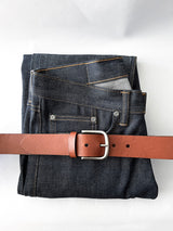 A pair of jeans with a Rogue Industries Baxter Leather Belt - 1.5" Wide.