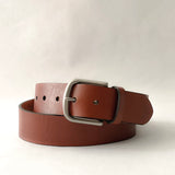 A brown premium cowhide leather Baxter Belt on a white background.