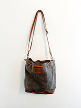 A Rogue Industries Kennebunkport Bucket Bag on a wall.