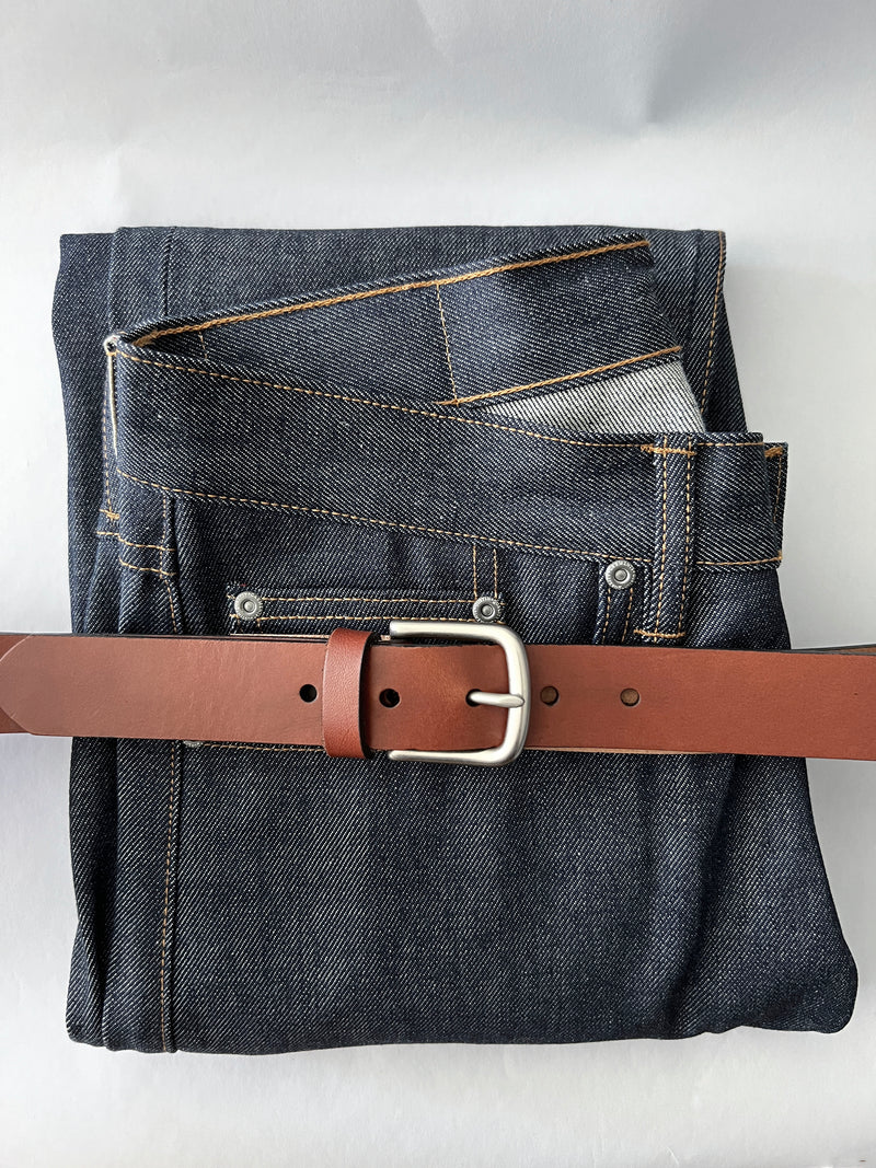 A pair of jeans with a Rogue Industries Chamberlain Leather Belt - 1.25" Wide.