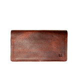 A brown Rogue Industries leather checkbook cover on a white background, crafted in a Maine workshop.