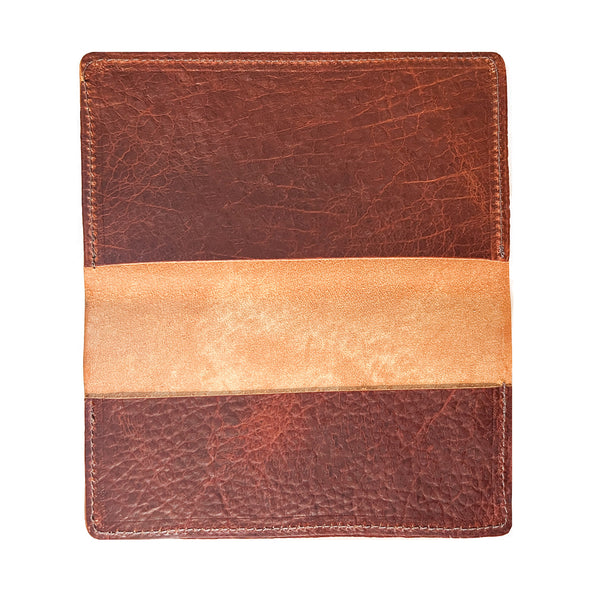 A brown and tan Rogue Industries American Bison leather checkbook cover on a white background, crafted in a Maine workshop.