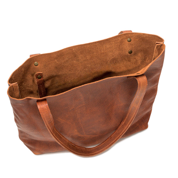 A brown full-grain leather Fore Street tote bag by Rogue Industries with a handle.