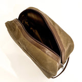 A durable tan and brown Rogue Industries Waxed Canvas Dopp Kit toiletry bag on a white surface, made in the USA.