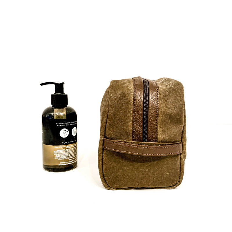 A durable, brown Rogue Industries Waxed Canvas Dopp kit with a bottle of soap next to it, made in the USA.