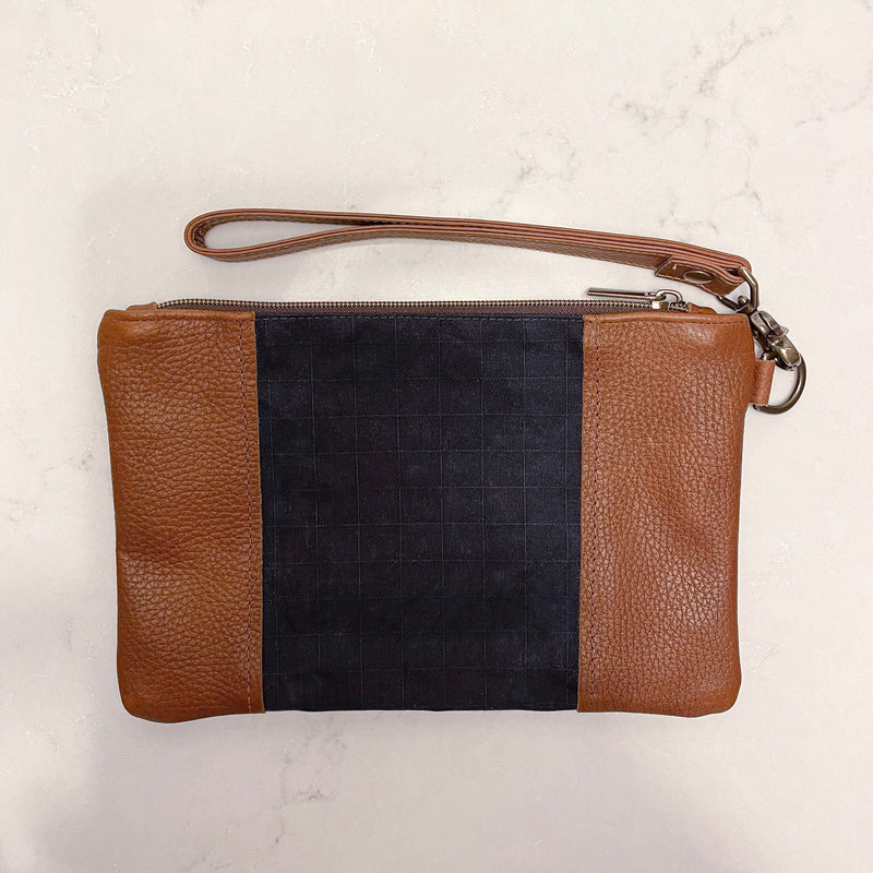 A Rogue Industries Eastport Clutch with a black stripe.