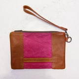 A tan and pink Rogue Industries Eastport Clutch with a strap.