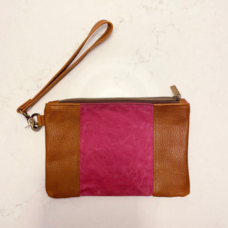 A tan and pink Eastport Clutch by Rogue Industries with a zipper.