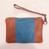 A blue and tan Rogue Industries Eastport Clutch with a strap.