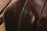 A close up of a brown Rogue Industries Katahdin Leather Briefcase with zippers.