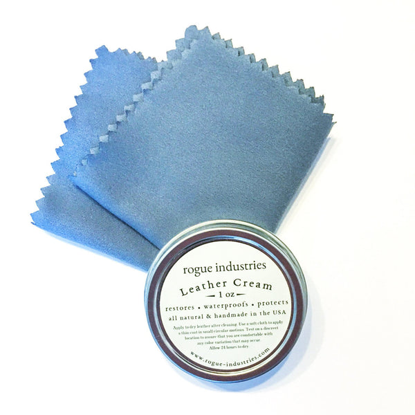 A blue cloth next to a tin of Rogue Industries All Natural Leather Cream.