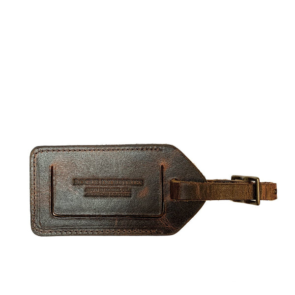 A brown Rogue Industries cowhide leather luggage tag on a white background, Made in Maine.