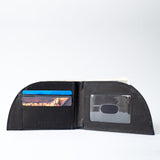A black Rogue Front Pocket Wallet in Alligator Leather with a credit card in it.