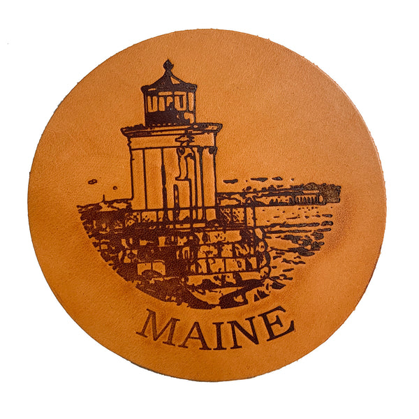 A Maine Lighthouse Coaster Set with the Rogue Industries logo on it.