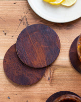 A set of Rogue Industries' Moose Leather Coaster Set on a wooden table.