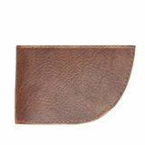 A slim brown leather wallet from Rogue Industries, known as the Factory Second PREVIOUSLY EMBOSSED Made in Maine Front Pocket Wallet - BROWN, features visible stitching and a slightly curved corner on the bottom right.