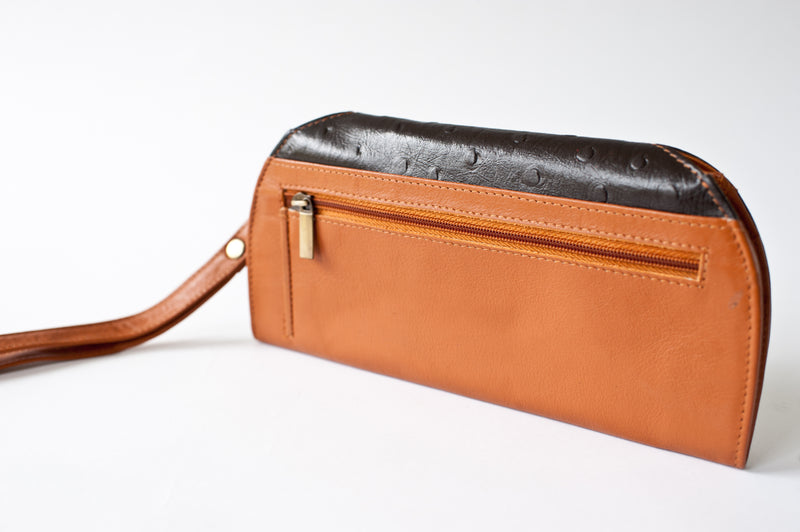 A brown and black leather RFID Blocking Clutch - Ostrich Print by Rogue Industries.