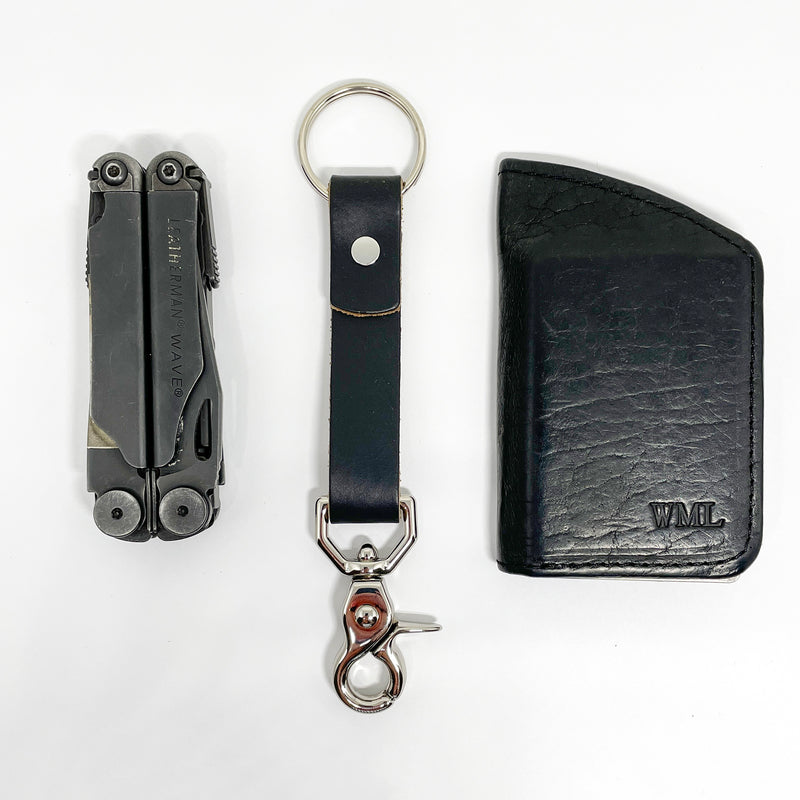 A durable Rogue Industries leather key chain with a nickel rivet and a pair of scissors.