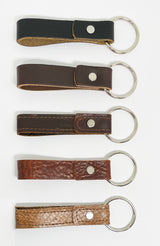 Four durable Rogue Industries leather key chains in different colors, each with a nickel rivet.