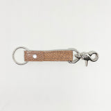 A tan, durable Rogue Industries leather keychain on a white background.