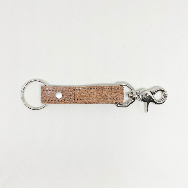 A tan, durable Rogue Industries leather keychain on a white background.