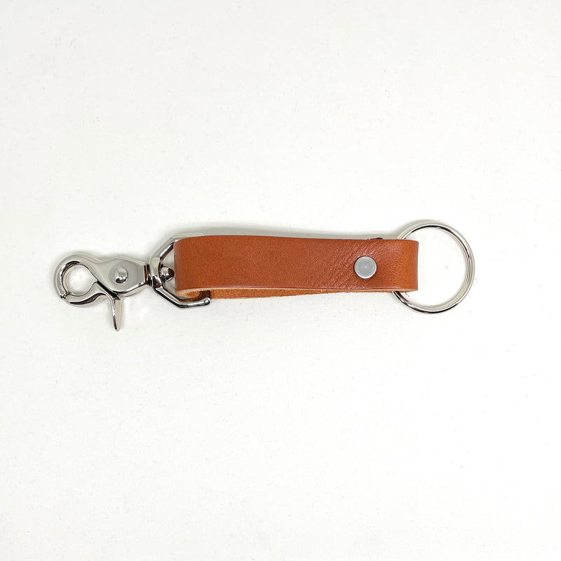 A tan Rogue Industries Leather Key Chain with a durable metal hook and nickel rivet.