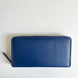 A blue premium leather smartphone clutch by Rogue Industries on a white surface.
