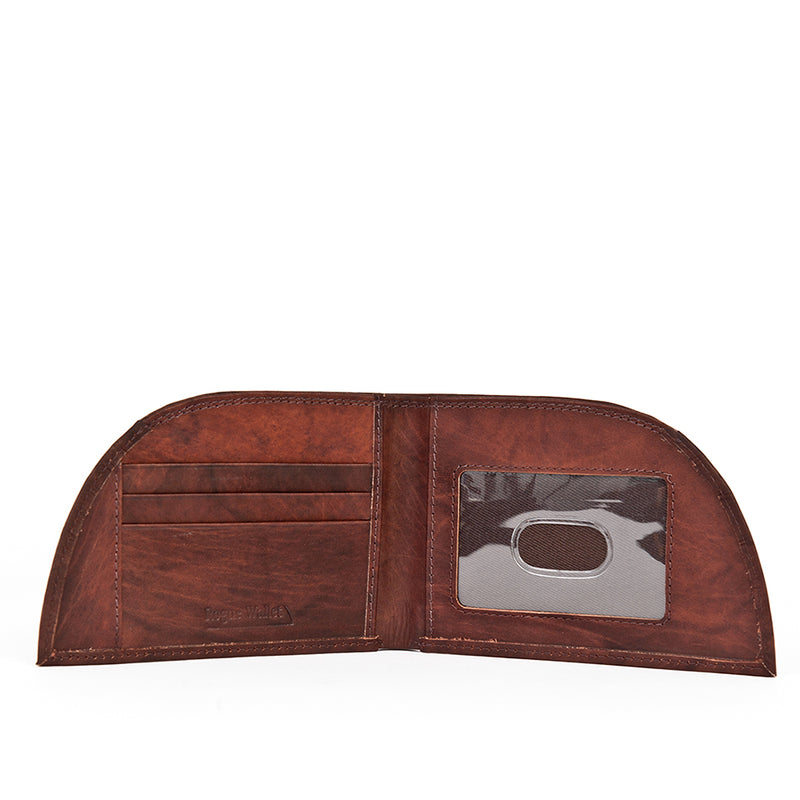 A brown premium cowhide wallet with a silver label from Rogue Industries.