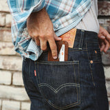 A man is holding a Rogue Industries Bison Card Case in his jeans pocket.