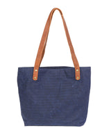 A durable, blue waxed canvas Allagash River Tote Bag with tan handles, crafted in Maine by Rogue Industries.