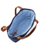 A durable, blue waxed canvas Allagash River Tote Bag with tan handles by Rogue Industries.