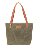 A durable, green waxed canvas Allagash River tote bag with brown leather handles, made by Rogue Industries in Maine.