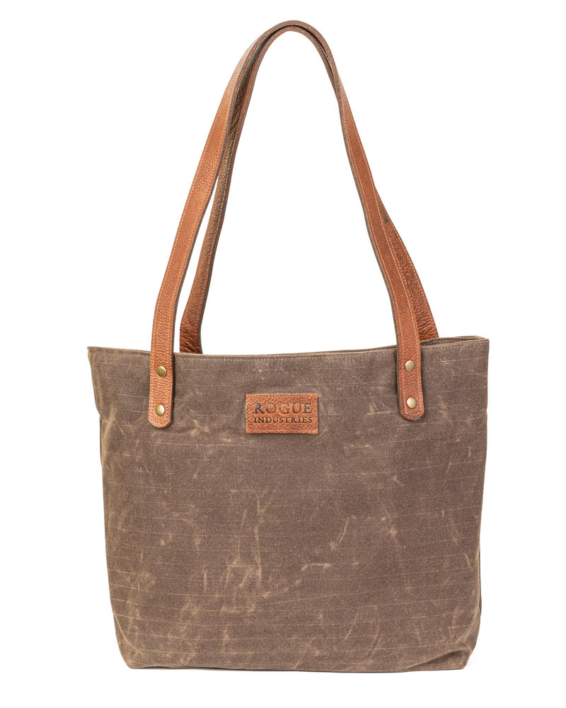 A durable Allagash River tote bag with brown leather handles by Rogue Industries.