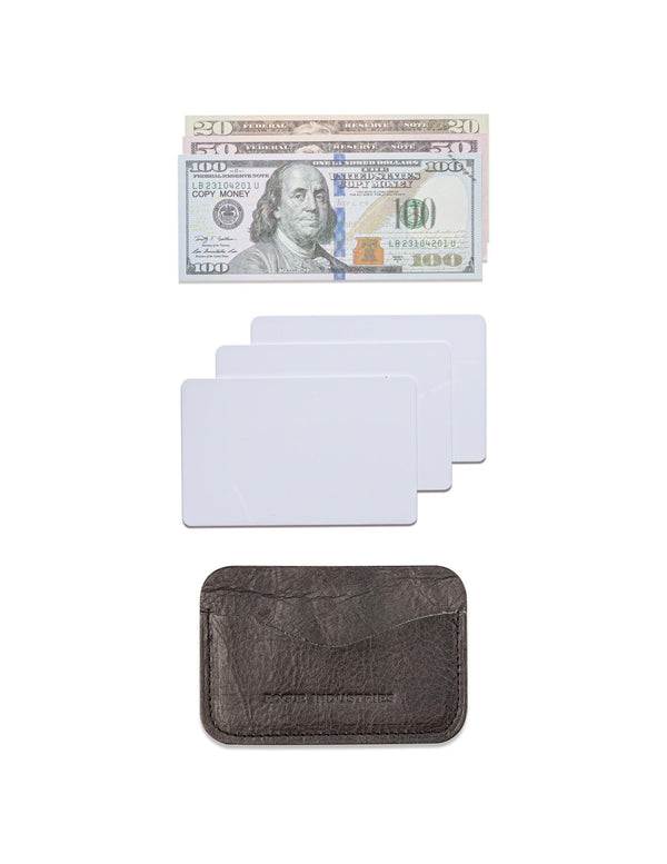 A Rogue Industries Bison Card Case with a dollar bill and a credit card.