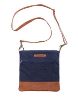 A blue and brown waxed canvas Ellis River crossbody bag by Rogue Industries.