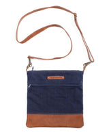 A blue and brown waxed canvas Ellis River crossbody bag by Rogue Industries.
