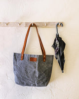 A durable Rogue Industries Allagash River Tote Bag hanging on a wall.