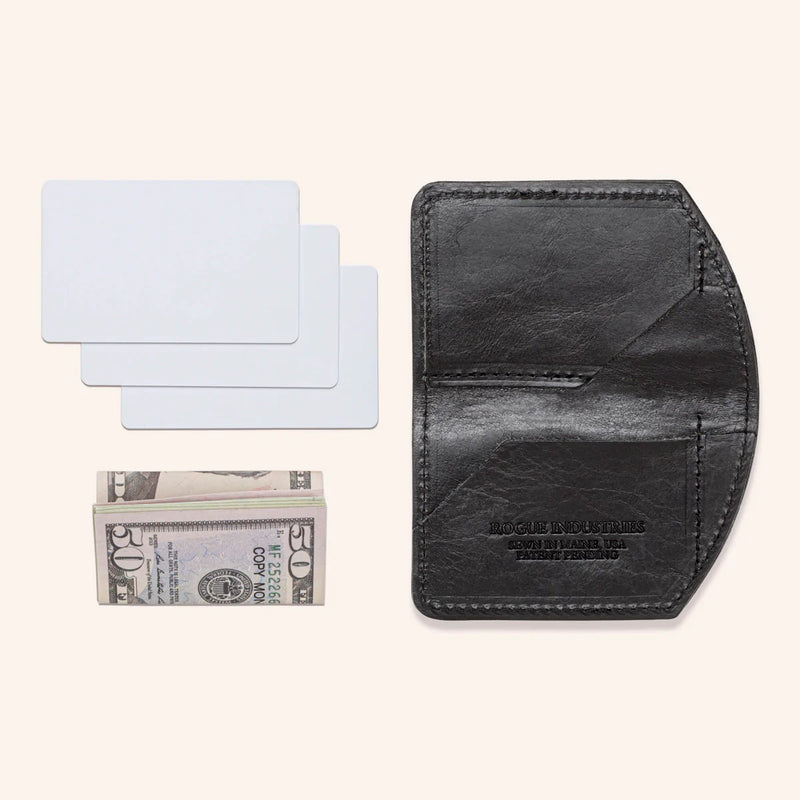 A black Rogue Industries Chamberlain Belt and Minimalist Wallet Bundle with a dollar bill and a credit card.