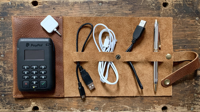 A top-grain leather Rogue Industries Leather Tech Organizer with a cell phone and cables.