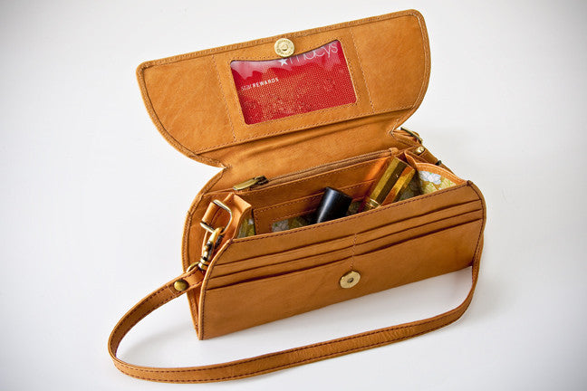 A brown leather RFID Blocking Clutch - Ostrich Print with a red card and a red plastic card inside by Rogue Industries.